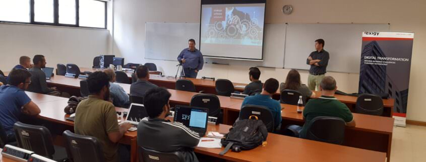 IT professionals giving presentation to university students in classroom