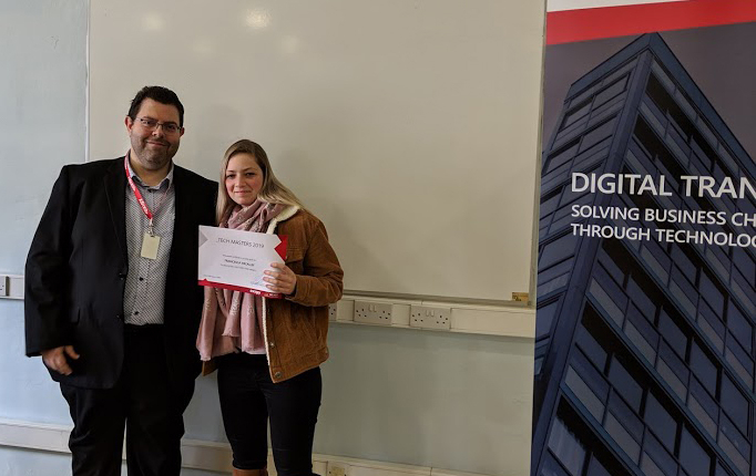 female student taking photo with ceo in classroom, shaking hands