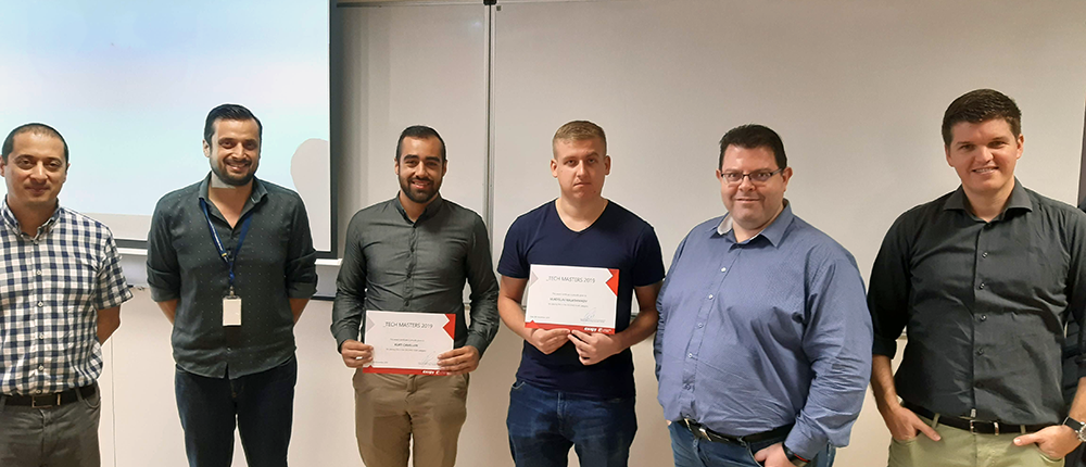 group of students taking photo with ceo and employee in a classroom