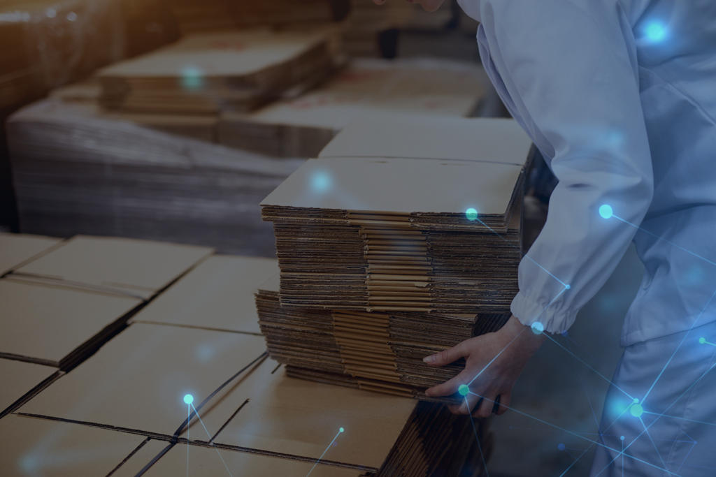 employee at manufacturing plant loading boxes on technological background