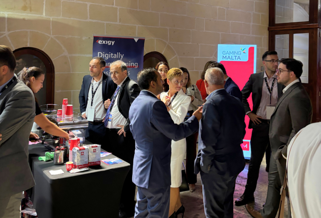 Attendees engaging with the Exigy team at their stand during EY Future Realised 2025 in Valletta.