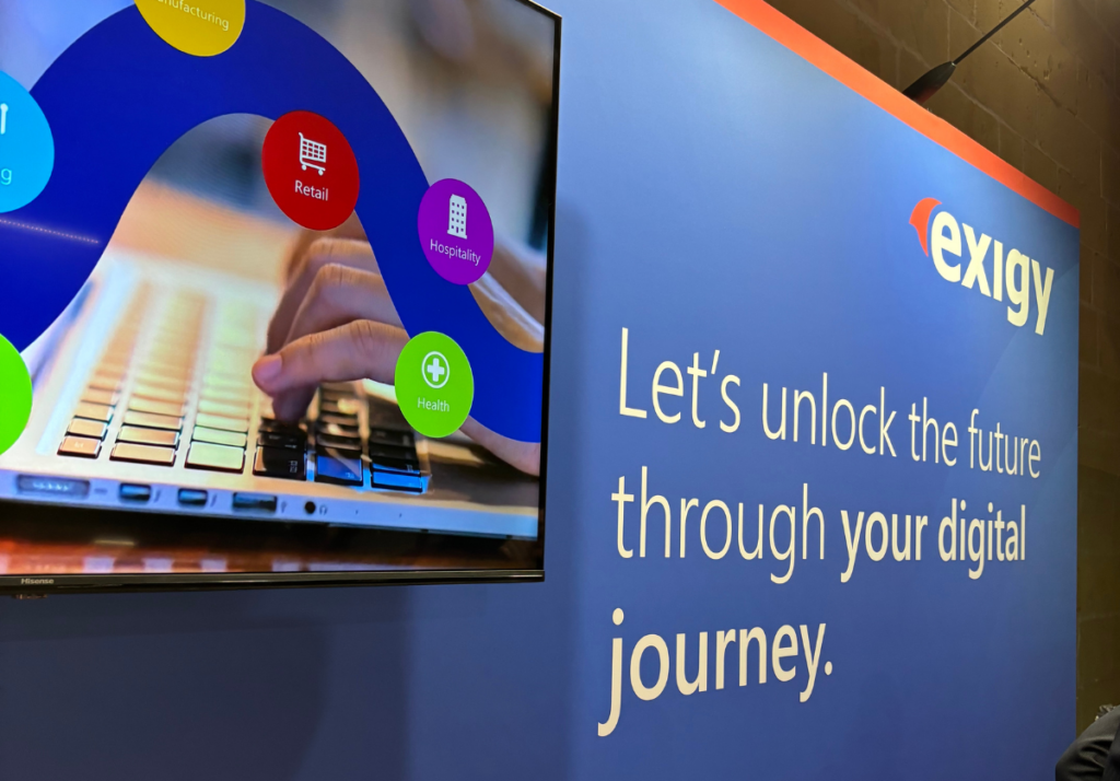 Close-up of Exigy’s exhibition stand at EY Future Realised 2025, featuring the company’s message “Let’s unlock the future through your digital journey.”