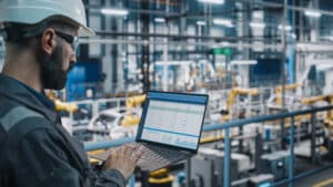 Employee using software to manage supply chain